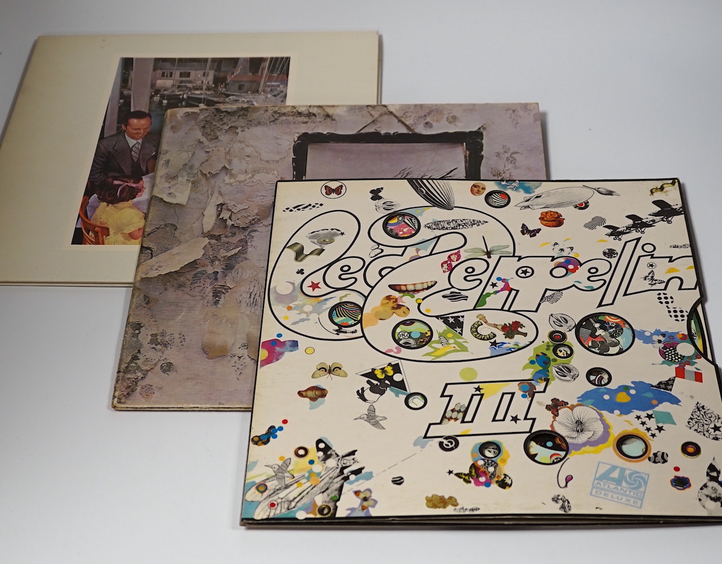 Three Led Zeppelin LP record albums; Led Zeppelin III with green and orange label (K50002), Led Zeppelin IV with red and maroon label (2401012) and Porky/Picko Duck runouts, and Prescence (SSK59402)